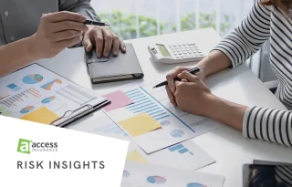 Business professionals reviewing charts and graphs for business continuity planning.
