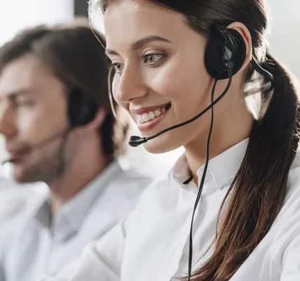 Smiling customer service reps with headsets, possibly discussing Charity Insurance.