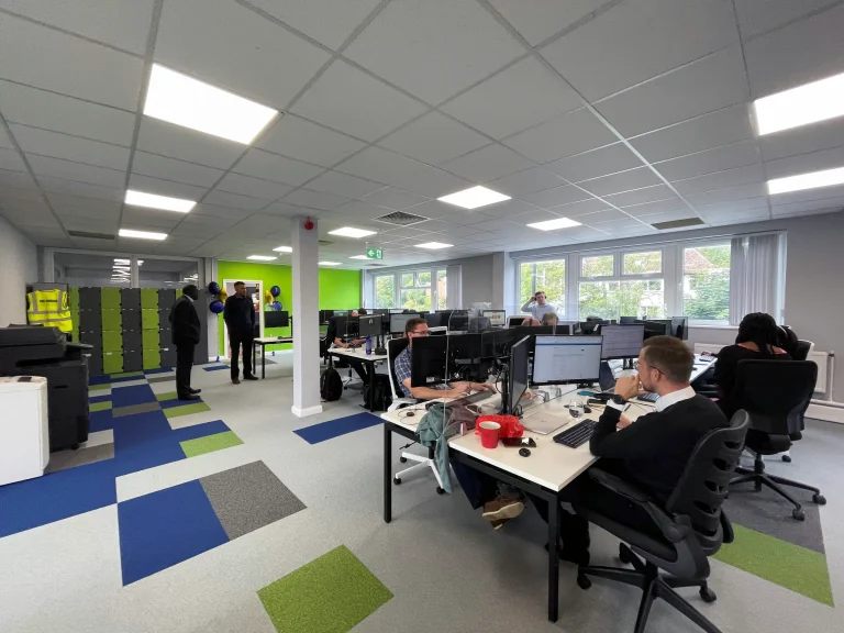Modern office with employees working at desks, promoting career opportunities.
