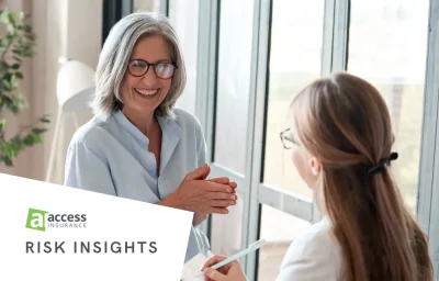 Woman smiling, consulting with local insurance broker.