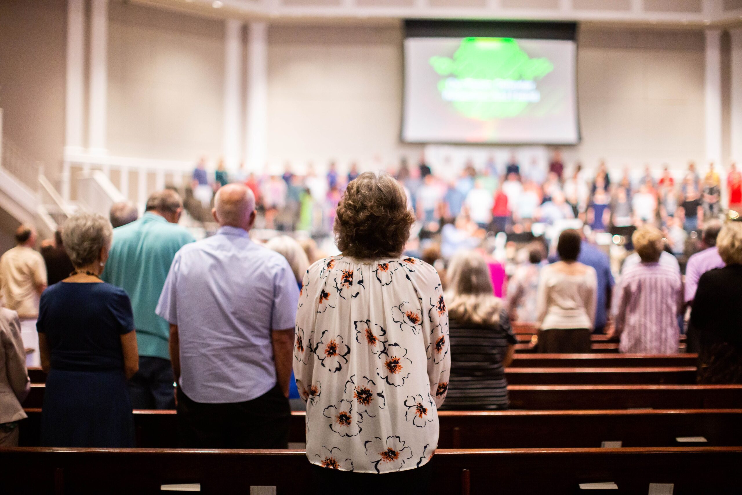 Congregation attending a church service with a projection screen in the background